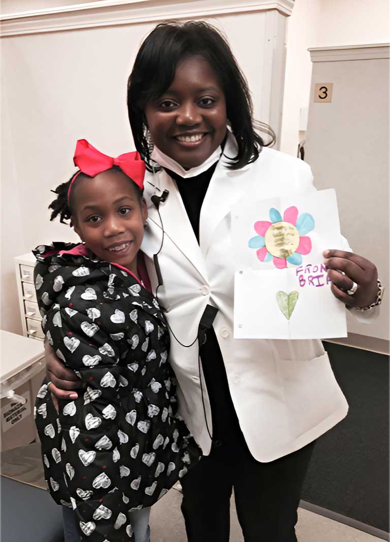 Smiling photo of Dr. White with a patient